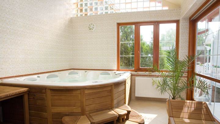 Wooden Bathtub And White Interior In Bathroom